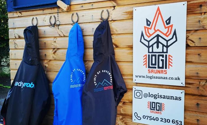 Enjoy the cozy ambiance of Logi Saunas at Wild Lakes while hanging up your dry robes, embracing the soothing warmth and comfort within the inviting sa